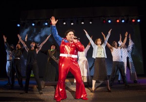 Richard Ruiz (center) croons Neil Diamond's "America" at the manic conclusion of American Night—The Ballad of Juan Jose, through Oct. 13 at the Yale Repertory Theatre. Photo by T. Charles Erickson.